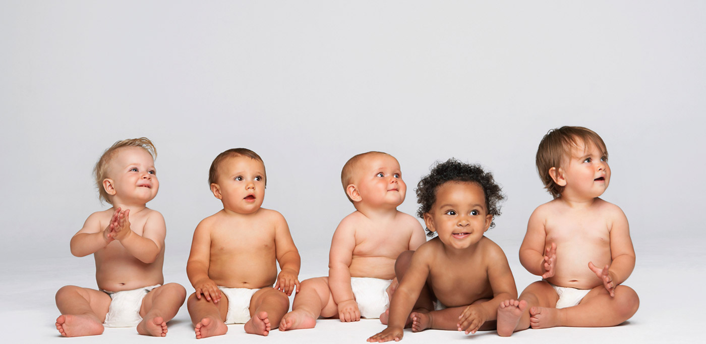 Five babies in diapers sitting together — representing the families Candace has helped grow through surrogacy, egg donation, and embryo donation law